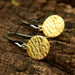 Gold Plated Brass Discs Earrings With Texture And Hangs On Sterling Silver Oxidized Hook - By Metal Studio Jewelry