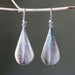 Silver leaf shape earrings with textured on oxidized sterling silver hooks style - by Metal Studio Jewelry